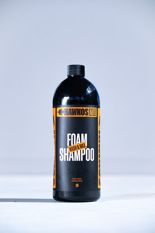 Thick foam from Hawkos Wash and Wax shampoo on a car panel